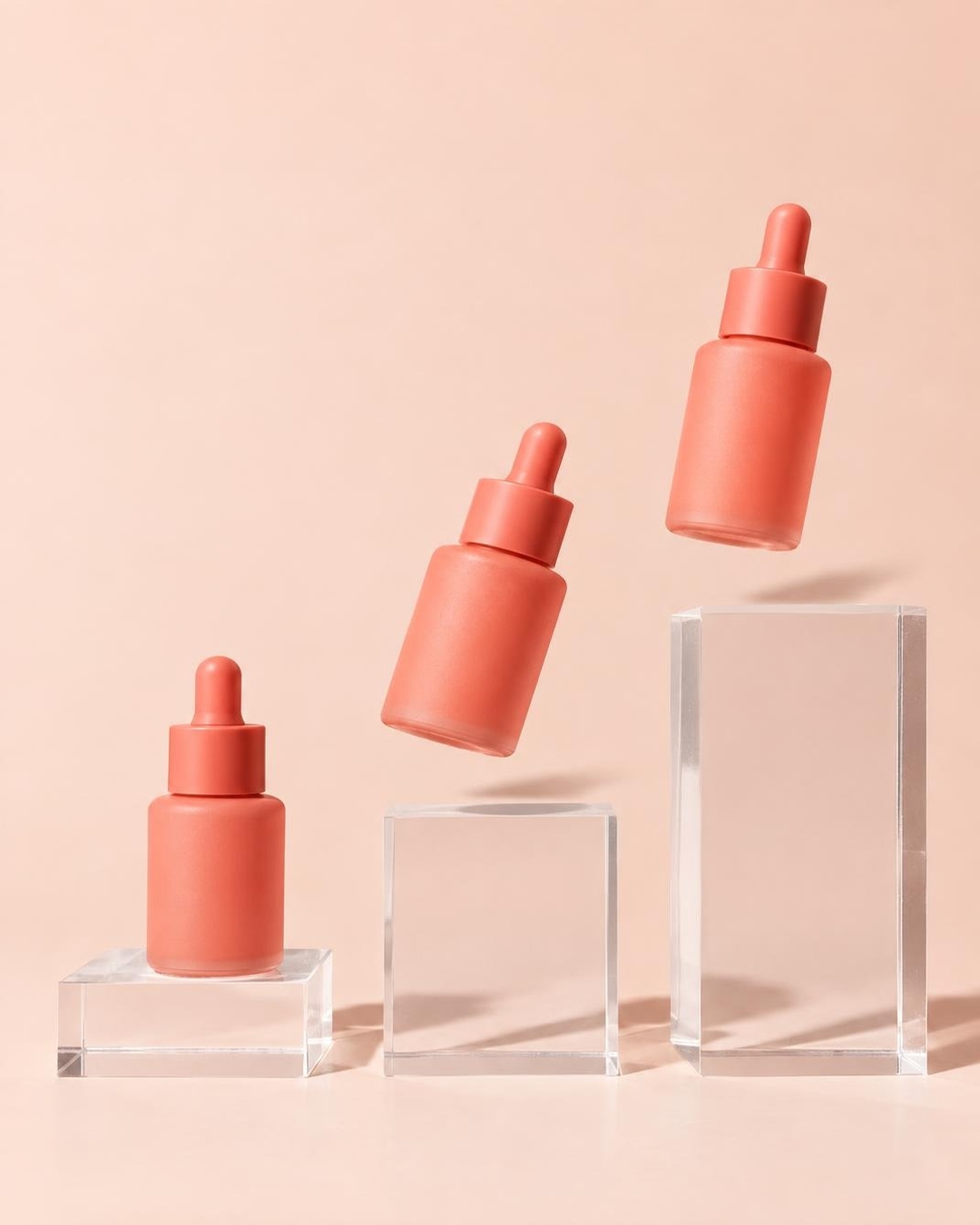 Stop motion product effect with a coral serum bottle hopping between plinths