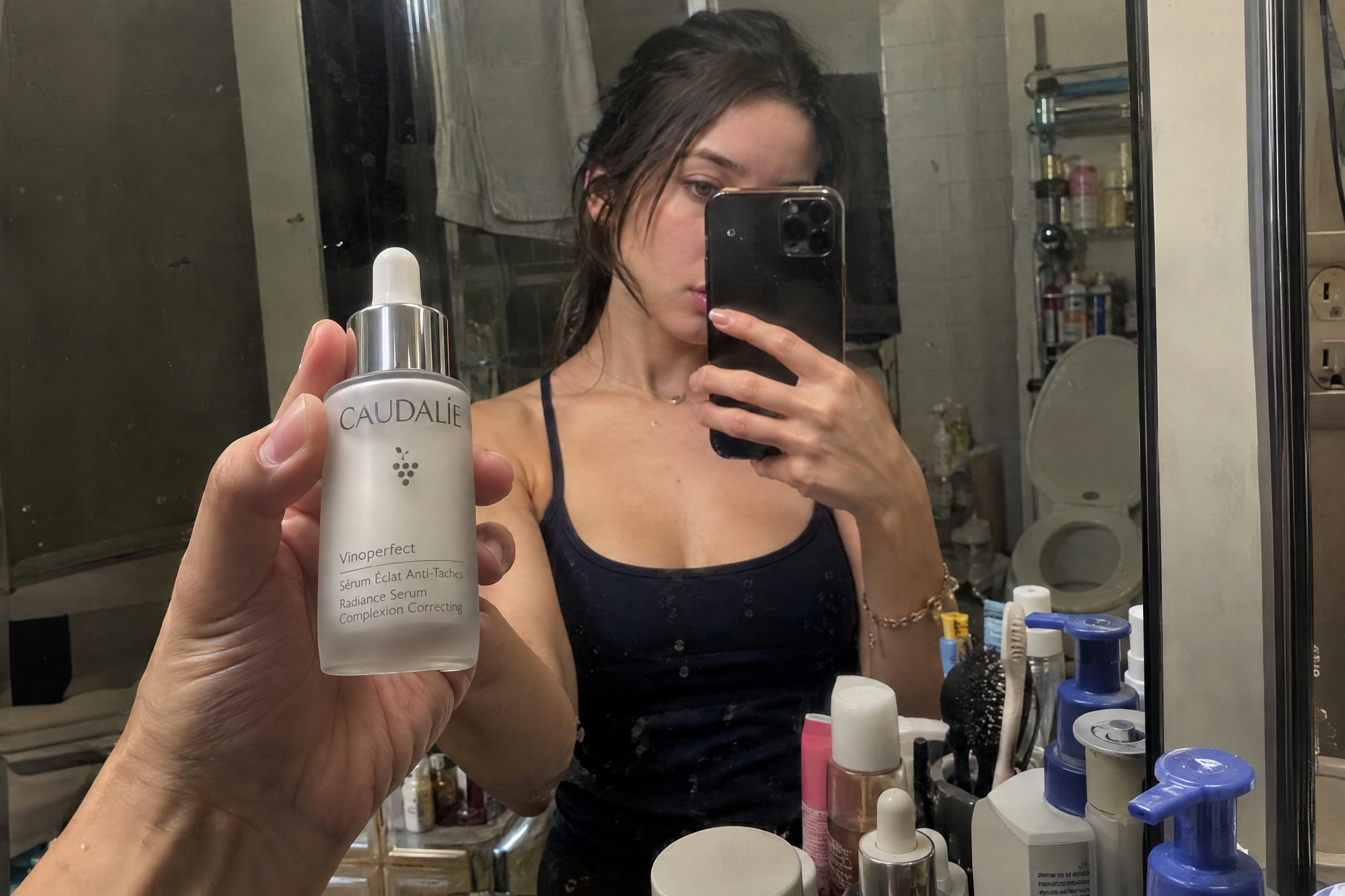 viral product ad mirror selfie with a face serum bottle